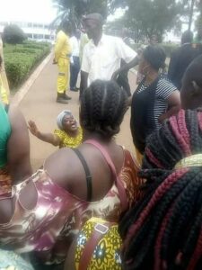 Sympathizers stares as Cameroonian woman wails