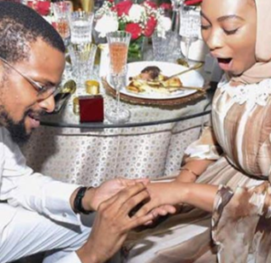 Abolaji Ajimobi, fixing a ring into Fatima Ganduje's hand