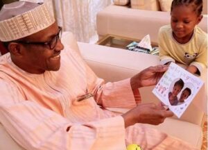 President Buhari's grand-daughter presents him with a birthday card