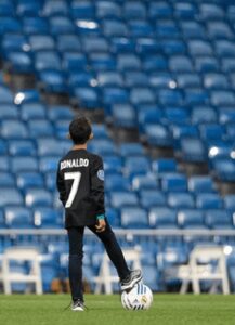 Cristiano Ronaldo son at Santiago Bernabeu Stadium on Saturday jogging a ball