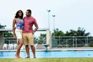Intending couple stand beside each other for a pool side prewedding shoot