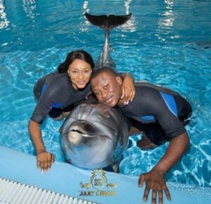 The intending couple in a pose with a dolphine